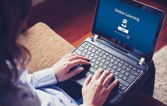 Woman hands over the laptop keyboard.